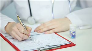 doctor signing paperwork